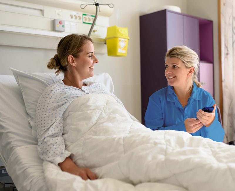 Conversation between doctor and patient in bed